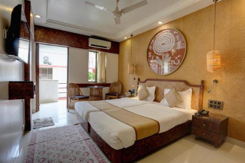 a bedroom with a large bed in a room at Accord Hotel in Mumbai