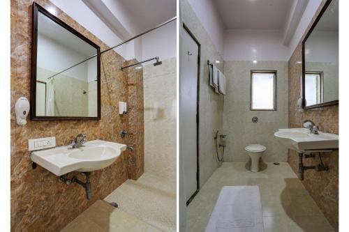 a bathroom with a sink and a mirror and a toilet at Accord Hotel in Mumbai