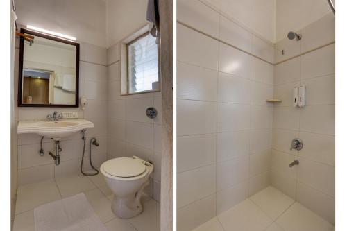 a bathroom with a toilet and a sink at Accord Hotel in Mumbai