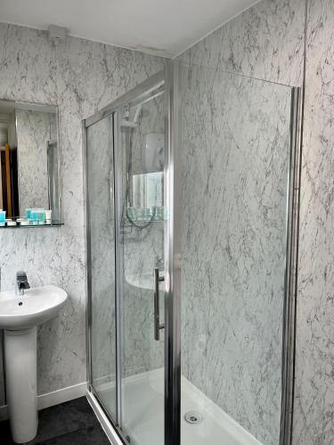 a bathroom with a shower and a sink at Riverside 1 in Dartmouth
