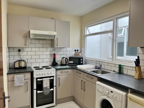 a kitchen with a sink and a stove top oven at Riverside 1 in Dartmouth