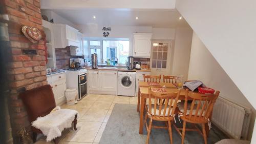 a kitchen with a table and chairs and a dining room at The Old Post Office Lodge in Enniskillen