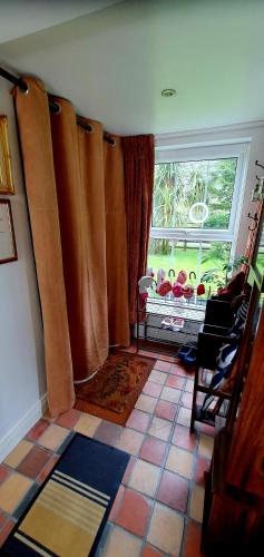 a living room with a large window with curtains at The Old Post Office Lodge in Enniskillen