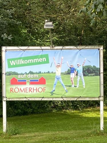 a billboard with three people jumping in the air at Scheunentraum Brenig in Bornheim