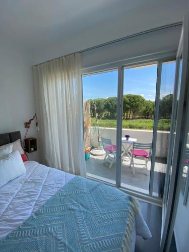 a bedroom with a bed and a view of a patio at Hanah Apartment - Gjiri Lalzit Lura 3 in Mullini i Danit