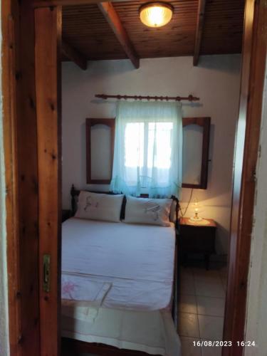 1 dormitorio con cama y ventana en Summer Sea Family House+Yard, en Sozopoli