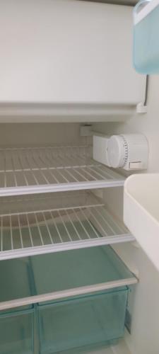 a refrigerator with a empty shelf in it at Apartment Cologne Center in Cologne