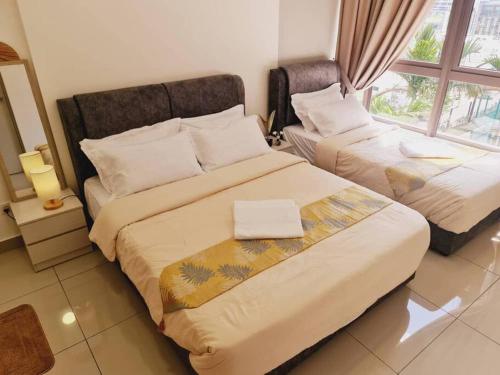 a bedroom with two beds and a window at New! Bali 5-8pax Melaka Town @ Play View Condo in Melaka
