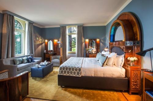 a bedroom with a bed and a living room at L'Albereta Relais & Chateaux in Erbusco