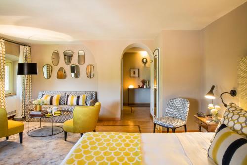 a living room with a couch and chairs at L'Albereta Relais & Chateaux in Erbusco