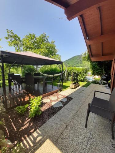 a patio with a table and chairs and an umbrella at Landhaus Manjul in Rammersdorf