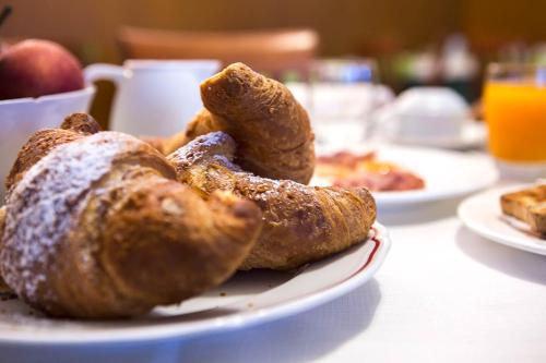 a plate of pastries sitting on a table at Hotel Patriarchi in Aquiléia