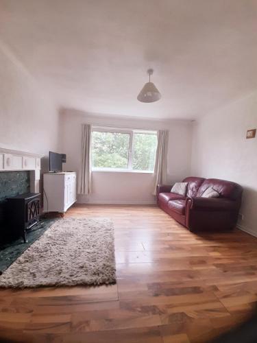 a living room with a couch and a fireplace at Self catering flat in Rotherham