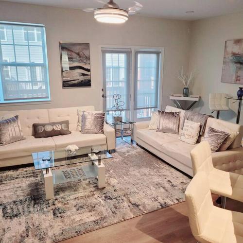 a living room with a couch and a table at Modern & Luxurious 3 Bdrm 2.5 Bath Townhome in Apex