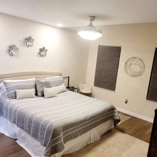 a bedroom with a bed with a blue and white blanket at Modern & Luxurious 3 Bdrm 2.5 Bath Townhome in Apex