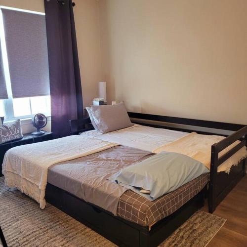 a large bed in a bedroom with a window at Modern & Luxurious 3 Bdrm 2.5 Bath Townhome in Apex