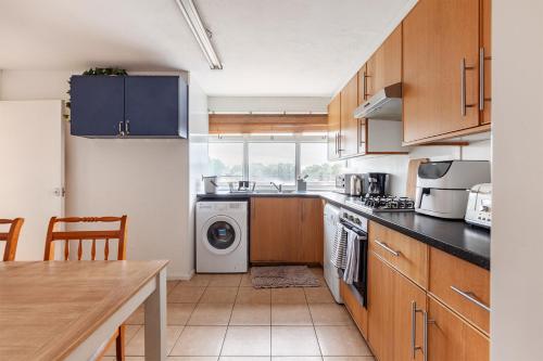 a kitchen with a washer and dryer at Spacious Room by Lee Valley White Water Centre. Waltham Cross in Waltham Cross