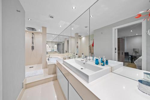 a bathroom with two sinks and a large mirror at Captivating 3-Bed House in London Holland Park in London