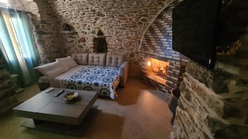 a living room with a couch and a fireplace at Olympus in Olýmpoi