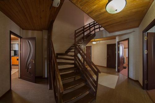 a wooden spiral staircase in a house with a ceiling at Alpina Resort by Stellar Hotels, Tsaghkadzor in Tsaghkadzor
