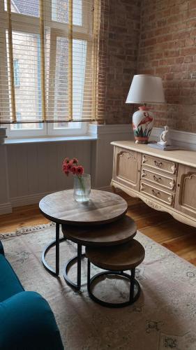 a living room with a coffee table and a dresser at Apartments PSD - Wojska Polskiego 5 in Słupsk
