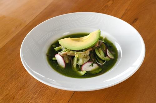 a bowl of soup with an avocado on top of it at Fiesta Inn Playa del Carmen in Playa del Carmen