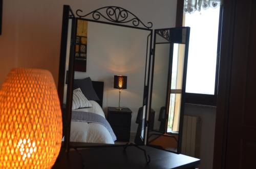 a bedroom with a bed with a large mirror at Villa Patrizia in Moncalvo