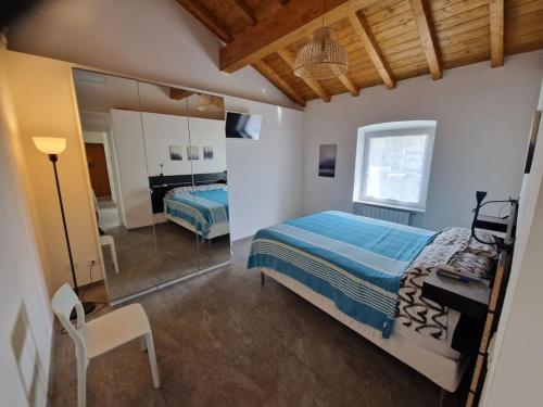 a bedroom with a bed and a desk and a mirror at ALL NEW and AIR-CONDITIONED La GRAZIOSA apartment in Genoa