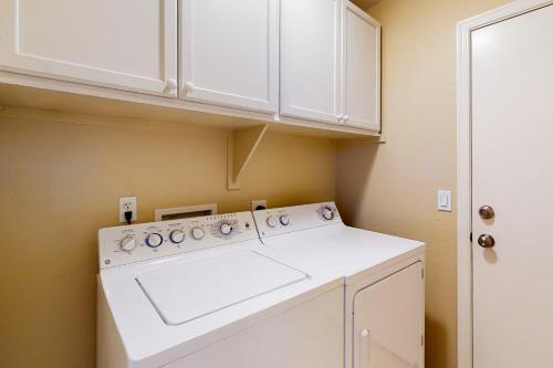 a white washing machine in a kitchen with white cabinets at Gold Canyon Getaway in Gold Canyon