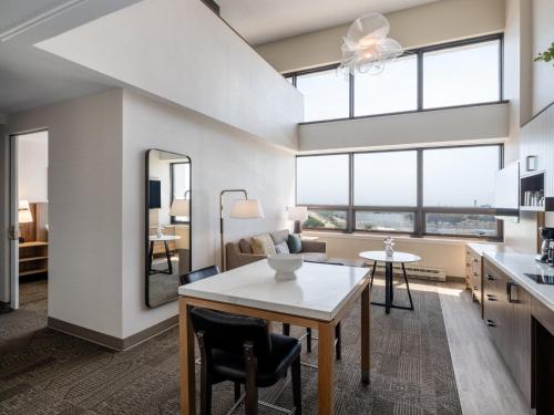 a kitchen and living room with a table and chairs at Staybridge Suites Chicago O'Hare - Rosemont by IHG in Rosemont