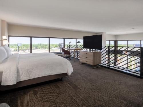 a bedroom with a bed and a flat screen tv at Staybridge Suites Chicago O'Hare - Rosemont by IHG in Rosemont