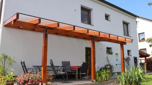 an outdoor patio with a wooden pergola at Ubytování EVA in Stará Říše