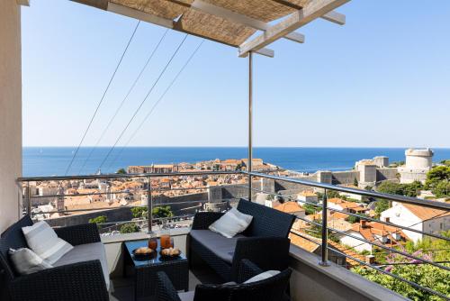 a balcony with chairs and a view of the ocean at Gjenero in Dubrovnik