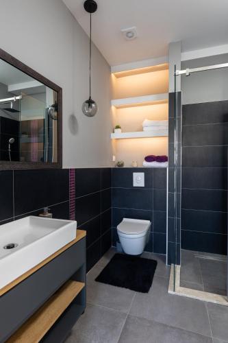 a bathroom with a sink and a toilet and a shower at Gjenero in Dubrovnik