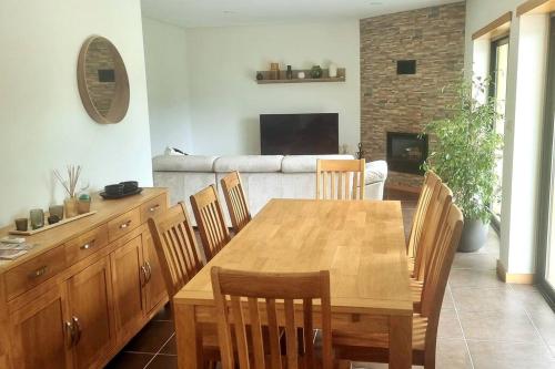 a dining room with a wooden table and chairs at Casa Picone - Gerês in Ventosa