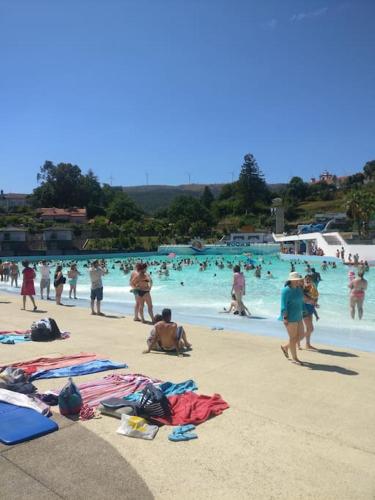 a group of people on the beach at a swimming pool at A casinha in Cerejeiras