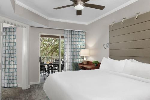 a bedroom with a large bed and a dining room at Marriott's Grande Ocean in Hilton Head Island