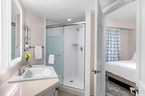 a white bathroom with a shower and a sink at Marriott's Grande Ocean in Hilton Head Island