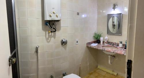 a bathroom with a sink and a toilet and a mirror at Aconchego no Rio in Rio de Janeiro