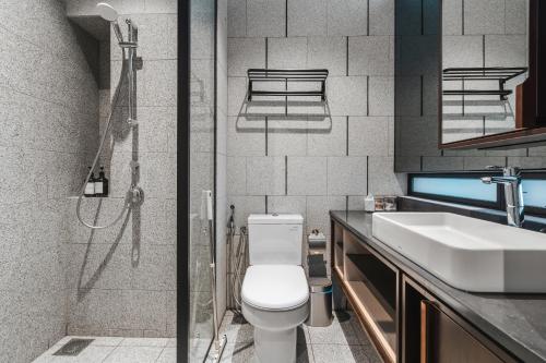 a bathroom with a shower and a toilet and a sink at Scarletz KLCC Apartments by soulasia in Kuala Lumpur