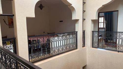 a balcony of a house with wrought iron railing at Ourika lodge the healing place in Tafza