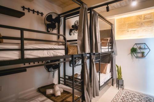 a group of bunk beds in a room at Mandera's Boutique Suites & Dorms in Valletta