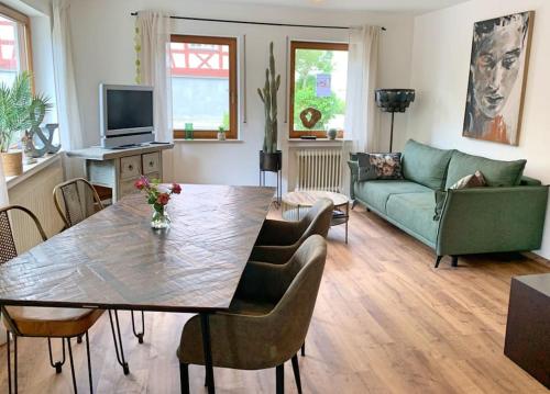 a living room with a table and a couch at Ferienwohnung am Bodensee in Singen