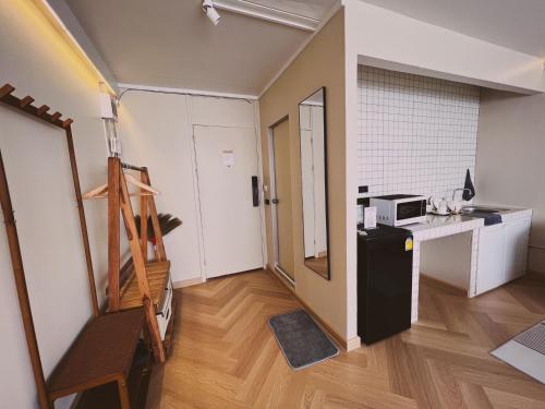 a small room with a refrigerator and a counter at Better Room ห้องพักรายวัน เมืองทองธานี C5 in Nonthaburi
