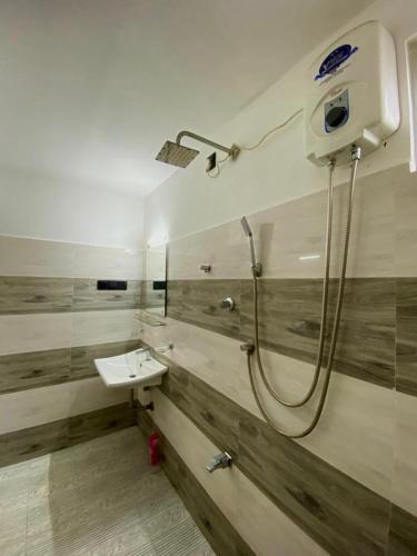 a bathroom with a shower and a sink at Home Stay Polhena in Matara
