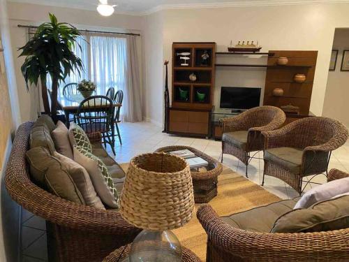 a living room with a couch and chairs and a fireplace at Apto Praia Mariscal in Bombinhas