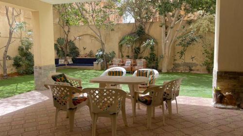 a patio with a table and chairs in a yard at Duplex villa in 6th Of October
