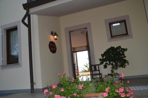 a house with a door and a window and flowers at Villa Patrizia in Moncalvo