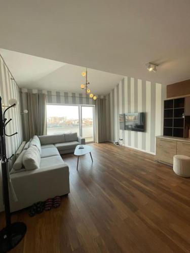 a living room with a couch and a table at Pleasant apartment with panoramic view in Prizren