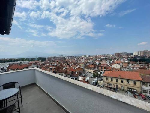 a balcony with a view of a city at Pleasant apartment with panoramic view in Prizren